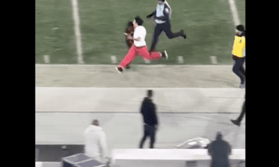 UCLA/USC Security Guard has the hit of the year on a young fan running on the field (Must See)